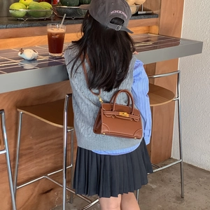Classic brown leather mini handbag for kids with gold hardware and shoulder strap