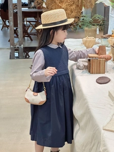 Detail view of mini beige and brown crossbody bag with chain strap for kids