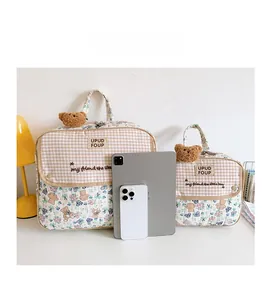Quilted floral and plaid storage bags in two sizes with plush bear charms and carrying handles