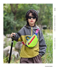 Detail of colorful kids chest bag in neon green and blue with adjustable strap buckle