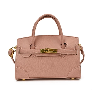 Pink cross-grain leather mini handbag with top handles and golden twist lock closure