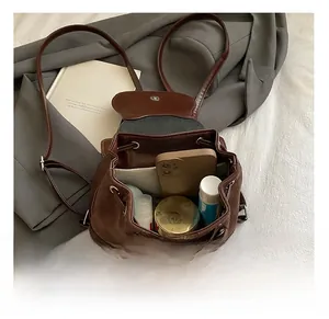 Detailed top view of brown bucket backpack showing large capacity for essentials