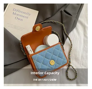 Internal capacity of mini blue denim quilted crossbody bag showing space for lipstick