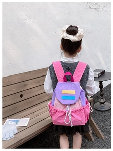 Kids color-block backpack with drawstring closure and side pockets shown on model