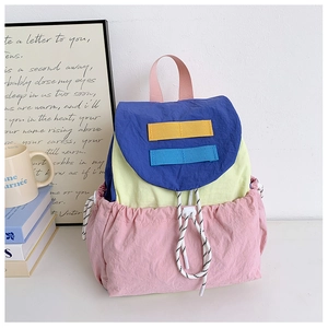 Close-up of color-block nylon backpack with drawstring closure and texture detail