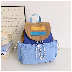 Detail of color-block kids backpack with drawstrings and premium nylon texture