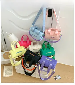 Macro detail of assorted colorful nylon mini bucket bags with letter prints and woven straps