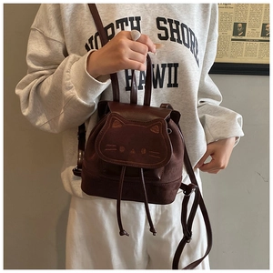 Detail view of brown cat-shaped mini backpack with embroidered ears and drawstring closure