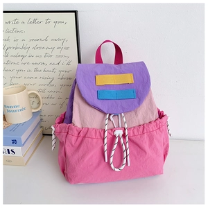 Close-up of kids drawstring backpack with multicolor nylon patchwork and strap details