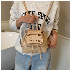 Detail of beige suede drawstring backpack with cute cat face embroidery and magnetic flap