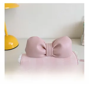 Detailed close-up of pink checkered kids mini bag with lace trim and bow design