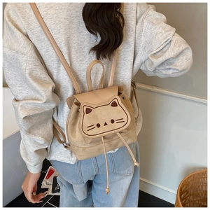 Close-up of beige toddler backpack with cute cat embroidery and soft matte texture