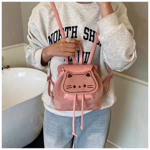 Detailed shot of pink cartoon cat backpack with velvet patchwork and embroidery