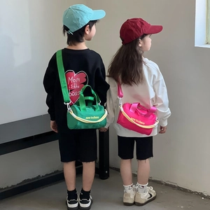 Kids stylish canvas bucket bag with wide strap and top handle in vibrant green and pink