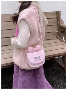 Detail of pink plaid kids crossbody bag with bow, lace trim and rhinestone buckle