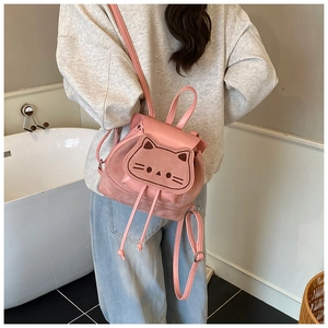 Pink toddler backpack with cute cat cutout detail and frosted texture on model's back
