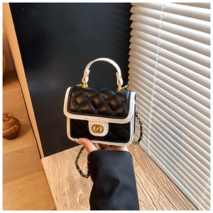 Detailed view of mini quilted crossbody bag with gold twist lock and chain strap