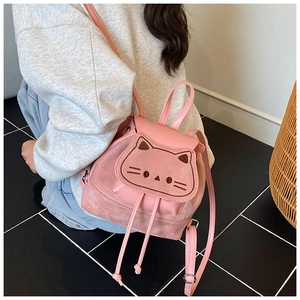 Detail of pink cat-shaped backpack featuring 3D ears and embroidered whiskers