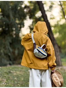 Detailed view of kids outdoor crossbody bag with contrast stitching and nylon texture