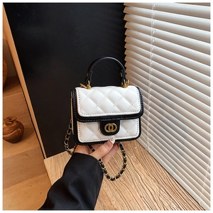 Detail of mini quilted chain bag with gold buckle and black trim on white leather