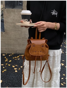 Close-up of caramel cartoon cat backpack with cute 3D ears and drawstring closure