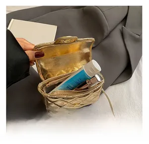 Interior view of gold quilted mini bag showing space for lipstick and hand cream