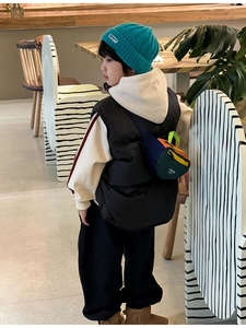 Kid stylish crossbody chest bag shown with outdoor casual outfit and blue knit hat