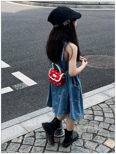 Girl's red polka dot crossbody bag paired with embroidered denim dress and beret hat