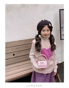 Close-up of pink checkered kids shoulder bag with lace trim and silver bow detail