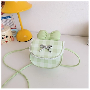 Detail of light green plaid mini shoulder bag with lace trim and large decorative bow