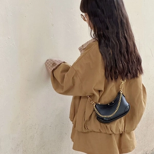 Chic black leathery crescent moon hobo bag with gold chain strap for stylish toddlers