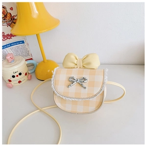 Detailed view of yellow plaid kids shoulder bag with lace trim and bow knot decor