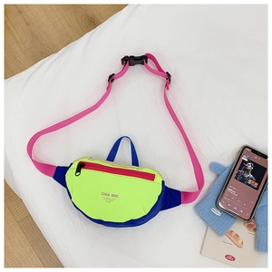 Detail of colorful canvas waist bag showing neon green and blue patchwork with pink strap