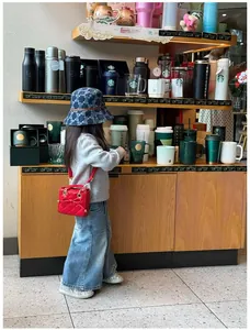 Close-up of quilted mini handbag with bow detail and denim bucket hat with pattern