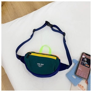 Detail of kids canvas waist bag featuring green fabric and vibrant color contrast zippers