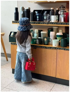 Toddler red quilted handbag with bow detail paired with casual autumn knitwear outfit
