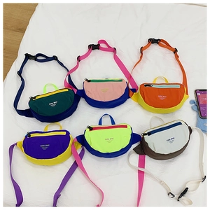 Flat lay of multiple colorful nylon crossbody chest bags for kids in diverse colorways