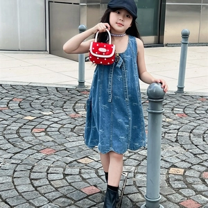 Girl's blue denim dress with white bow patterns and polka dot crossbody bag