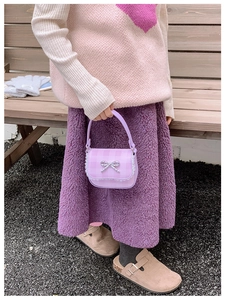 Detail of purple plaid mini bag with silver bow accent and delicate white lace trim