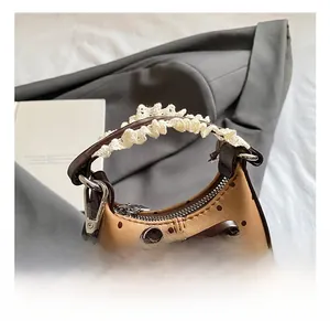Detail of brown polka dot handbag with bow and white lace wrapped handle