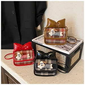 Detailed view of mini plaid crossbody bags with large bows and cute puppy patches