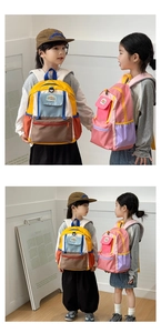 Detail of color-block school backpacks for kids in vibrant yellow and purple tones