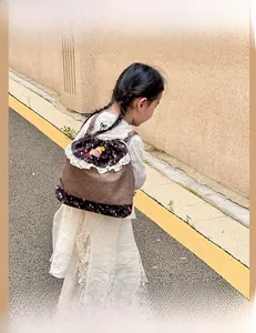 Back view of a child wearing a sweet Mori style drawstring backpack with lace trim.