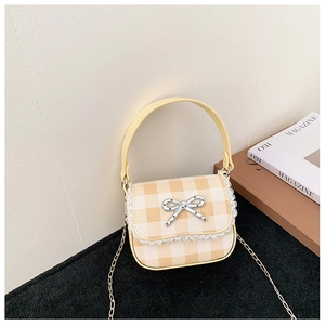 Close-up of yellow gingham mini bag featuring white lace trim and silver bow detail