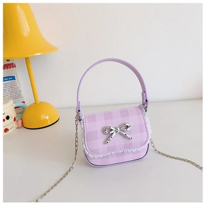 Close-up of purple plaid mini bag with white lace trim and silver bow accessory