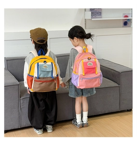 Detail view of colorful patchwork kids backpacks with multi-pockets and top handle