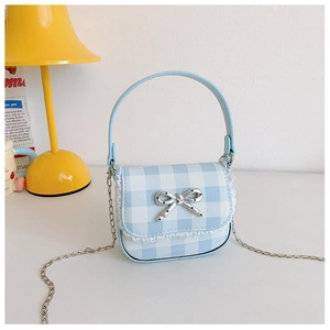 Detail of light blue checkered mini bag with white lace edges and silver bow metal buckle