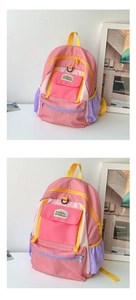 Detail of colorful nylon kids backpack showing contrast color pockets and brand patch