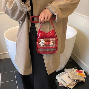 Red patent leather crossbody bag with cartoon dog charm and large bow for kids