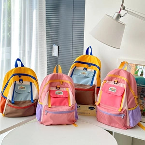 Detail of multi-pocket kids school bag with colorful patchwork design and zipper pockets